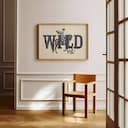 Room view with a full frame of A vintage linocut print, the word "WILD" with a woman on a horse