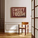 Room view with a full frame of A vintage linocut print, the words "SWEET TOOTH" with a cinnamon roll