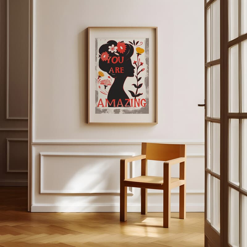 Room view with a matted frame of A vintage linocut print, the words "YOU ARE AMAZING" with a silhouette of a woman with flowers in her hair