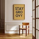 Room view with a full frame of A minimalist poster print, the words "STAY GROOVY"