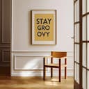 Room view with a matted frame of A minimalist poster print, the words "STAY GROOVY"