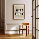 Room view with a full frame of A minimalist linocut print, the words "RISE AND SHINE"