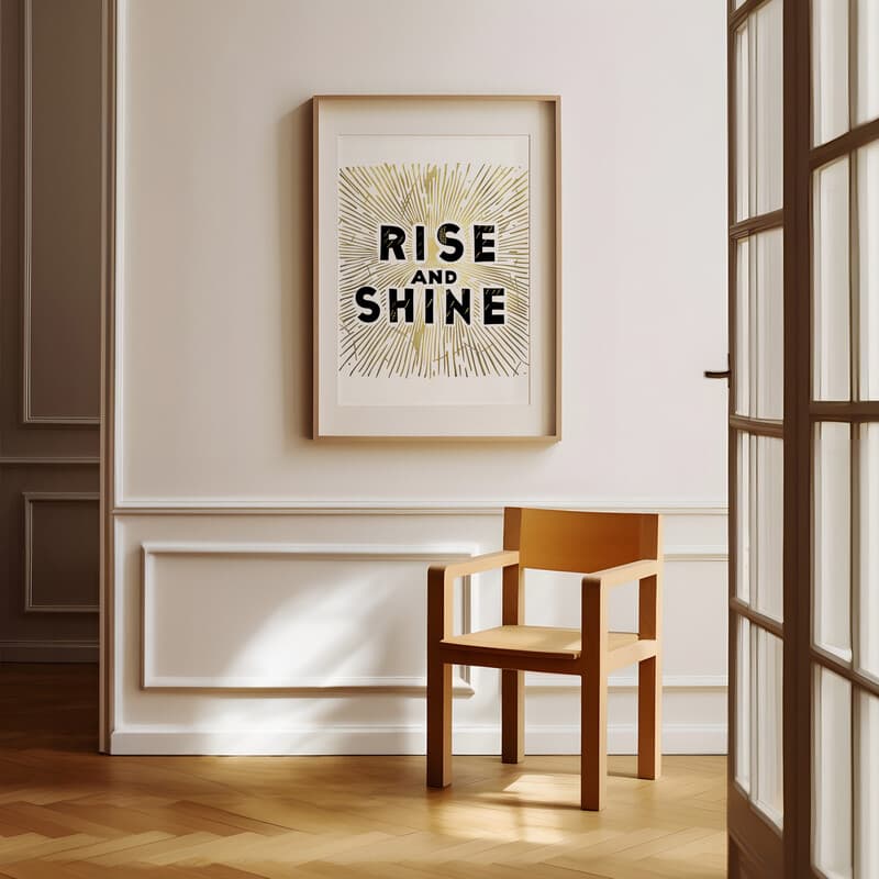 Room view with a matted frame of A minimalist linocut print, the words "RISE AND SHINE"