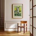 Room view with a matted frame of A vintage linocut print, the words "BE WHOLE" with a glass of lemonade