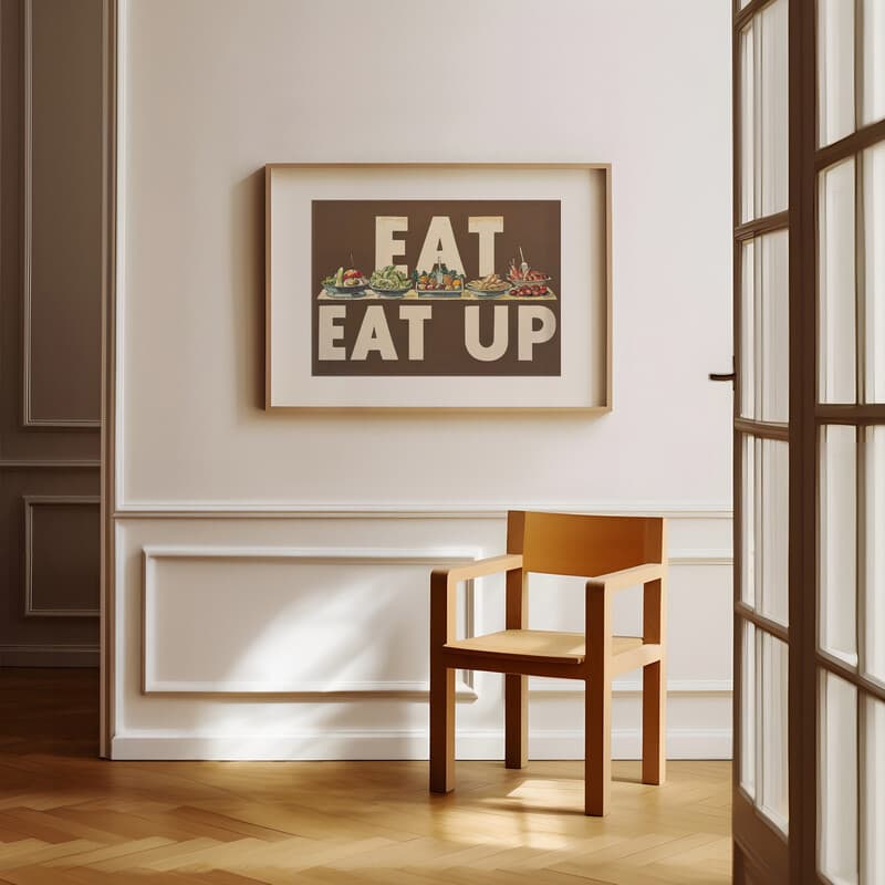 Room view with a matted frame of A vintage linocut print, the words "EAT UP" with a buffet of food
