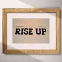 Matted frame view of A retro letterpress print, the words "RISE UP"