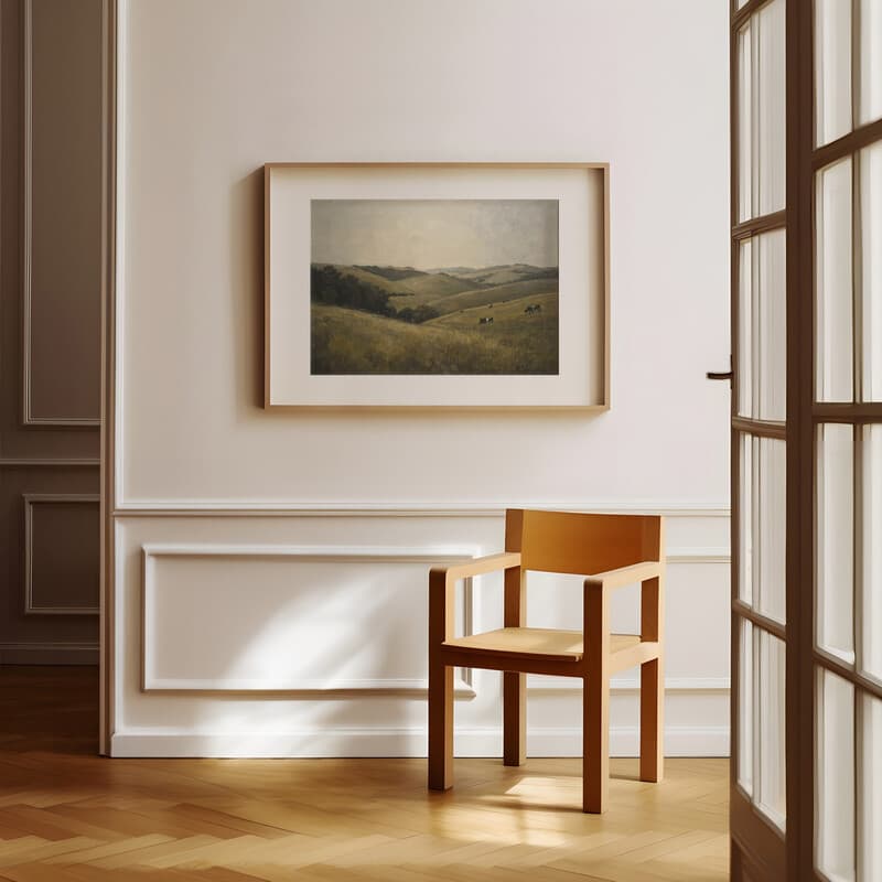 Room view with a matted frame of An impressionist oil painting, rolling hills, cows in the distance, gray sky