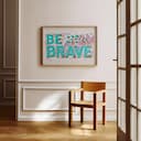 Room view with a full frame of A bauhaus linocut print, the words "BE BRAVE"