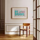 Room view with a matted frame of A bauhaus linocut print, the words "BE BRAVE"