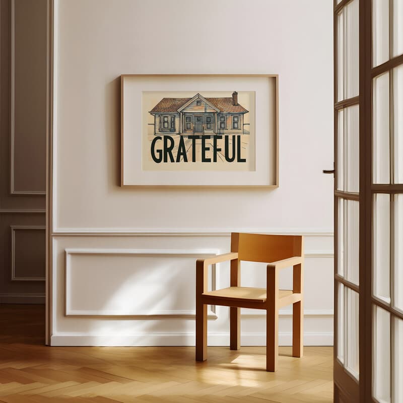 Room view with a matted frame of A vintage pastel pencil illustration, the word "GRATEFUL" with the front view of a small home