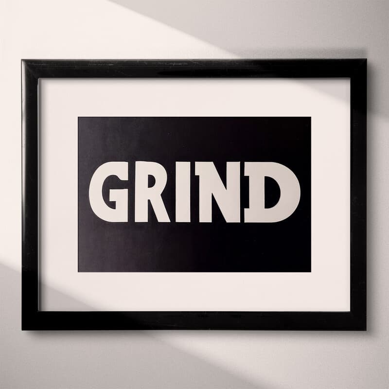 Matted frame view of A minimalist letterpress print, the word "GRIND"