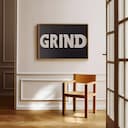 Room view with a full frame of A minimalist letterpress print, the word "GRIND"