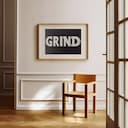 Room view with a matted frame of A minimalist letterpress print, the word "GRIND"