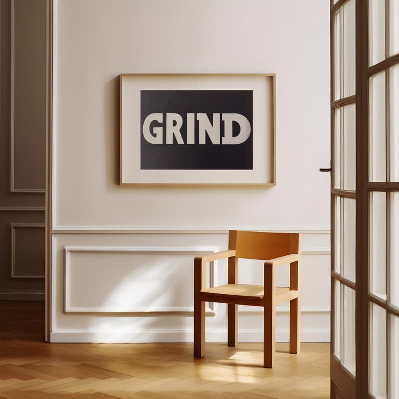 Room view with a matted frame of A minimalist letterpress print, the word "GRIND"