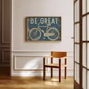 Room view with a full frame of A vintage linocut print, the words "BE GREAT" with a bicycle