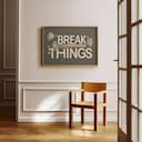 Room view with a full frame of A vintage linocut print, the words "BREAK THINGS" with a hammer