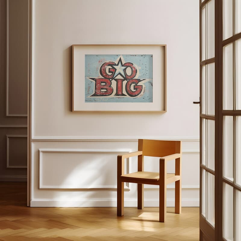 Room view with a matted frame of A vintage linocut print, the words "GO BIG" with a star