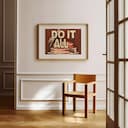 Room view with a matted frame of A vintage linocut print, the words "DO IT ALL" with a cake