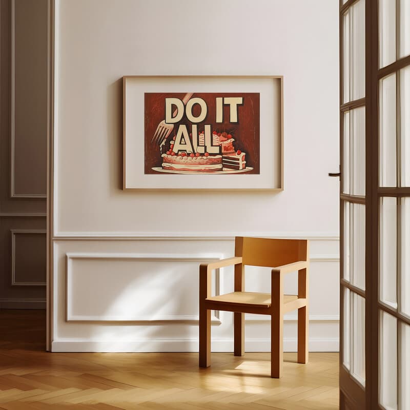 Room view with a matted frame of A vintage linocut print, the words "DO IT ALL" with a cake