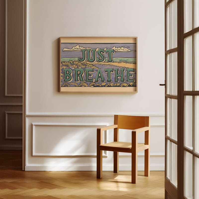 Room view with a full frame of A vintage linocut print, the words "JUST BREATHE" with a seashore