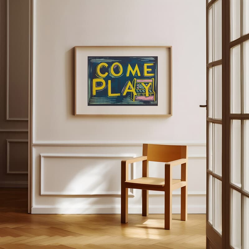 Room view with a matted frame of A vintage linocut print, the words "COME PLAY" with an arcade machine