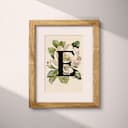 Matted frame view of A vintage pastel pencil illustration, the letter "E" with a flower