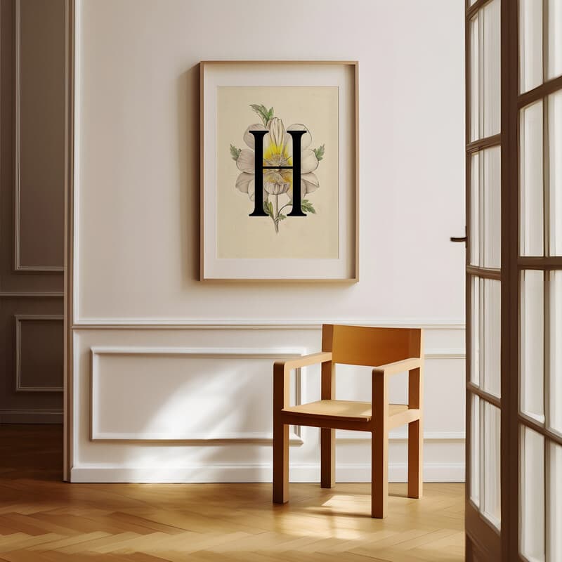 Room view with a matted frame of A vintage pastel pencil illustration, the letter "H" with a flower