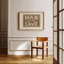 Room view with a matted frame of A vintage linocut print, the words "MAN CAVE" with a pool table