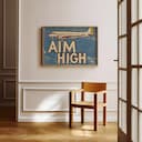 Room view with a full frame of A vintage linocut print, the words "AIM HIGH" and an airplane