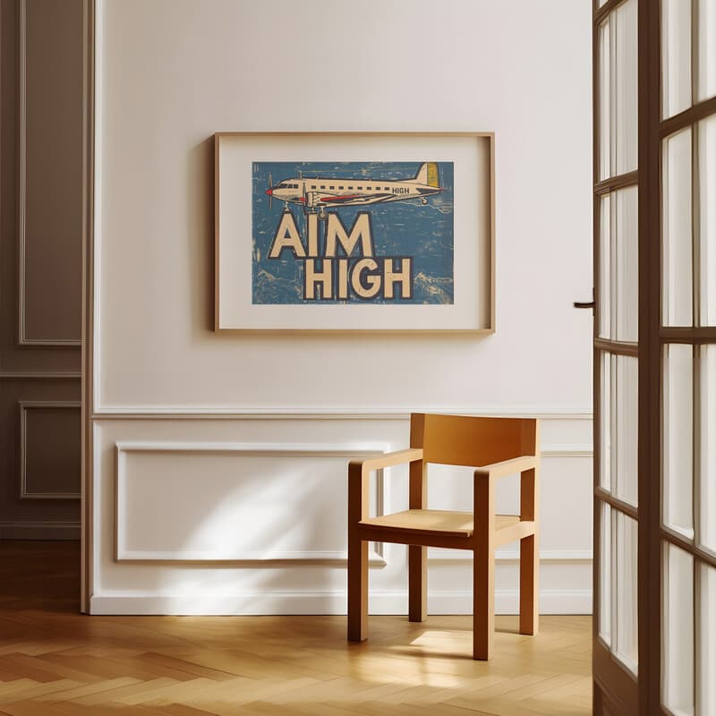 Room view with a matted frame of A vintage linocut print, the words "AIM HIGH" and an airplane