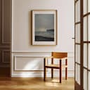 Room view with a matted frame of An impressionist oil painting, the ocean under a gray sky, a cliff in the distance