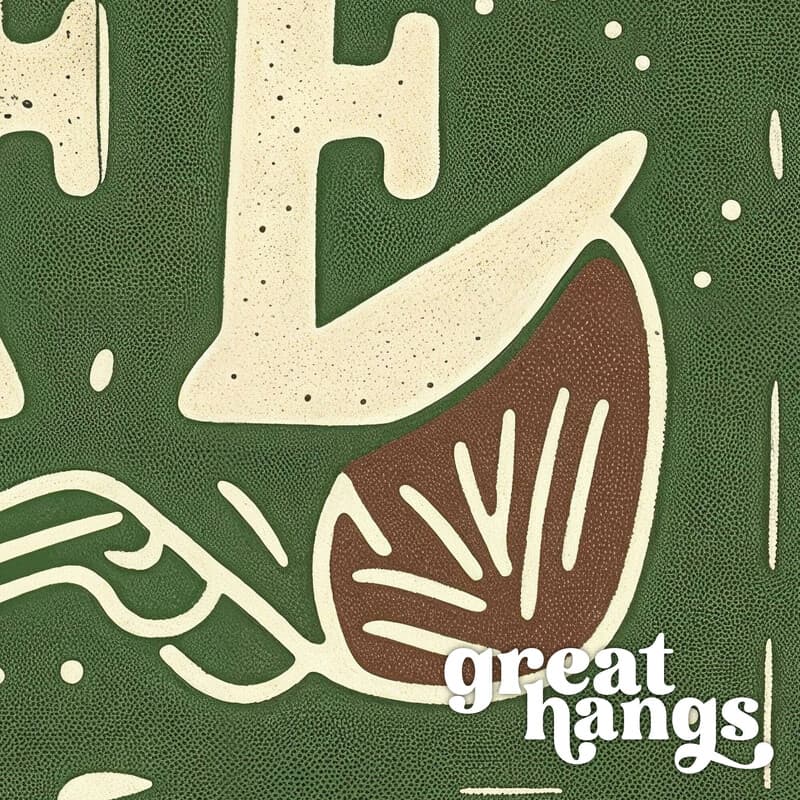 Closeup view of A vintage linocut print, the words "THE GOOD GOOD LIFE" with a pattern