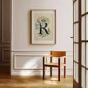 Room view with a matted frame of A vintage pastel pencil illustration, the letter "R" with a flower