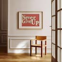 Room view with a matted frame of A vintage linocut print, the words "Never Give Up" in cursive