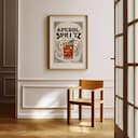 Room view with a matted frame of A vintage linocut print, the words "APEROL SPRITZ" with a spritz coctail