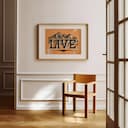 Room view with a matted frame of A contemporary linocut print, the words "LIVE" with mountains