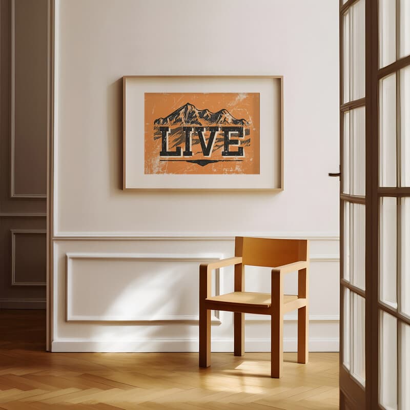 Room view with a matted frame of A contemporary linocut print, the words "LIVE" with mountains