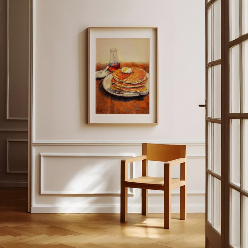 Room view with a matted frame of A farmhouse pastel pencil illustration, pancakes and syrup with a fork on a wood table