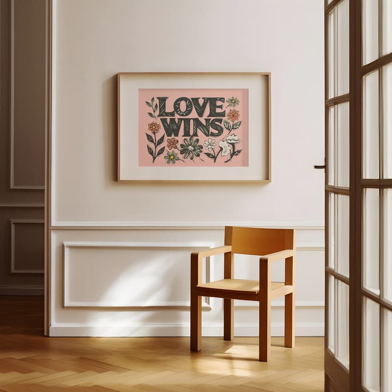 Room view with a matted frame of A bohemian linocut print, the words "LOVE WINS" with flowers