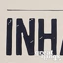 Closeup view of A contemporary letterpress print, the words "INHALE & EXHALE" with lines