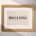 Matted frame view of A contemporary letterpress print, the words "INHALE & EXHALE" with lines