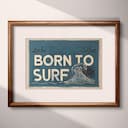 Matted frame view of A vintage linocut print, the words "BORN TO SURF" with a wave