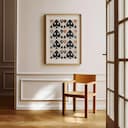 Room view with a matted frame of A mid-century textile print, symmetric pattern of spades and clubs